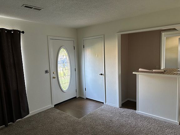 Living room / Entry Way and Small Bar area. New carpet