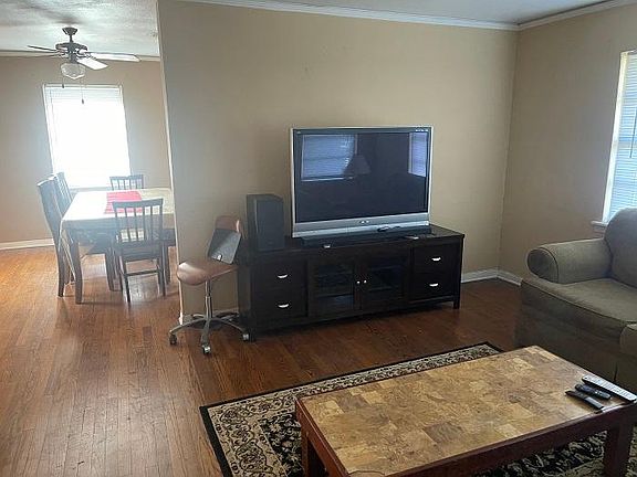 Large Screen TV in living room open to dining