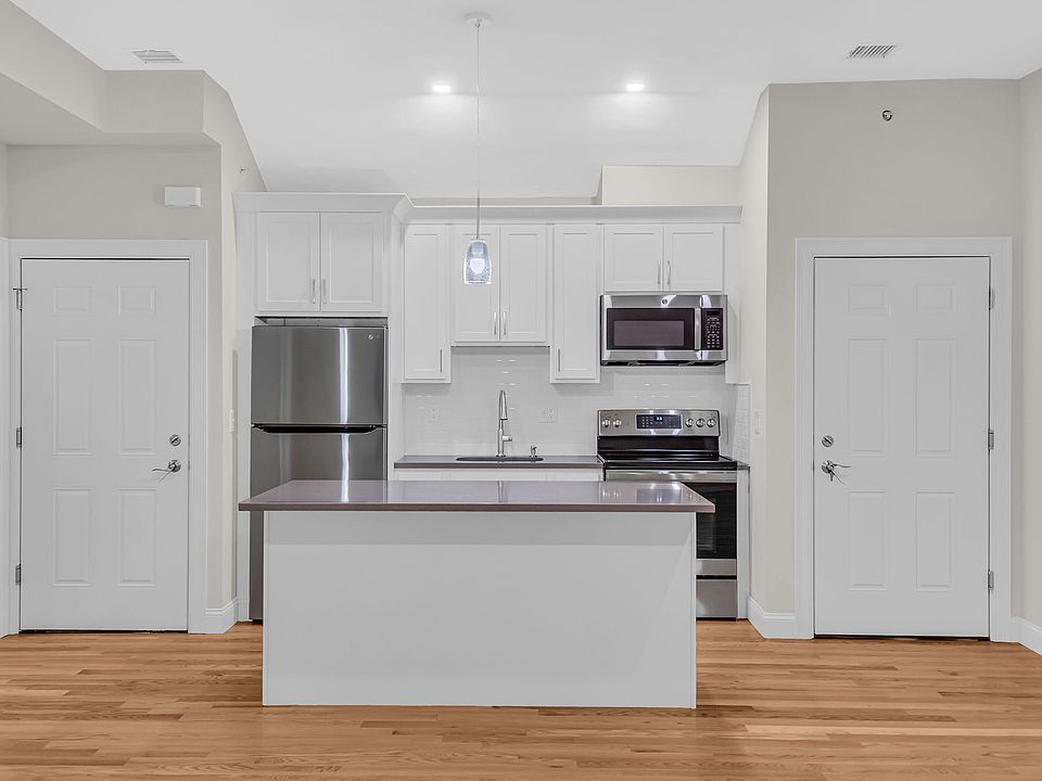 View of kitchen and both entry doors into interior main hallway.