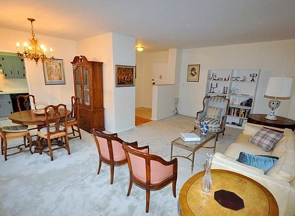 The large living room and "L" shaped dining room has covered parquet floors, wall of windows and overlooks the back courtyard.  The living room is 21'-0" x 12'-3" and the dining area is 10'-0" x 8'-3".