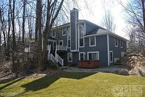 Exterior of Home with deep back yard with screened-in porch and attached deck.  Hot tub included.
