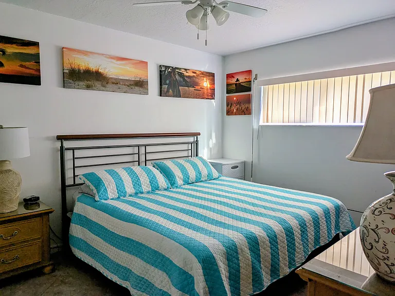 The master bedroom has a king-size bed and a TV.