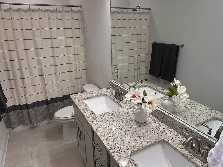 Owners bath with double vanity and tub shower combination