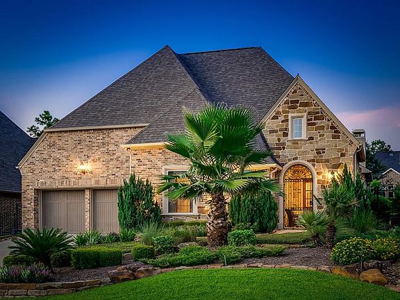 Beautiful lighting and landscaping surround this Darling Patio Home