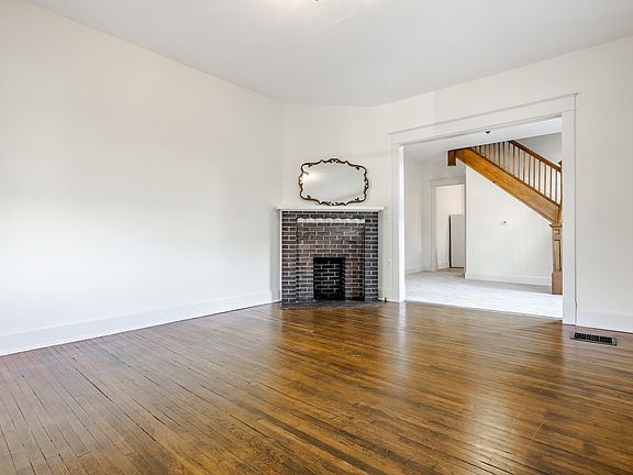 Front living room opens to central dining room/den with new carpet