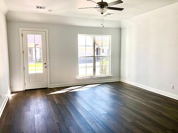 Spacious living room with large energy efficient double paneled windows letting light into the home