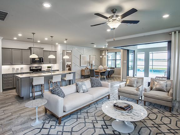 Open living and dining areas, gathering room with optional tray ceiling, recessed lighting, and tile