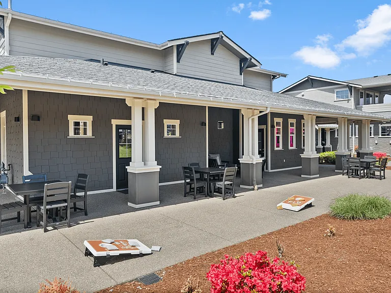 Relax and unwind in this inviting outdoor patio, complete with comfortable seating and fun lawn games.