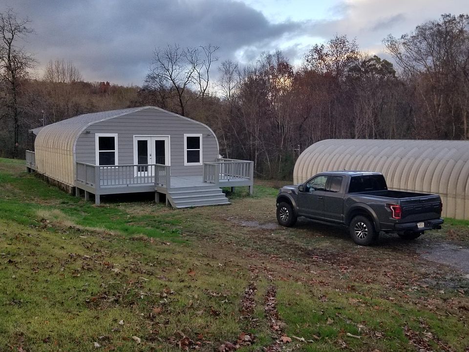 Front of house. Newly framed front wall with new siding, doors and windows. Deck is sturdy and recently painted.