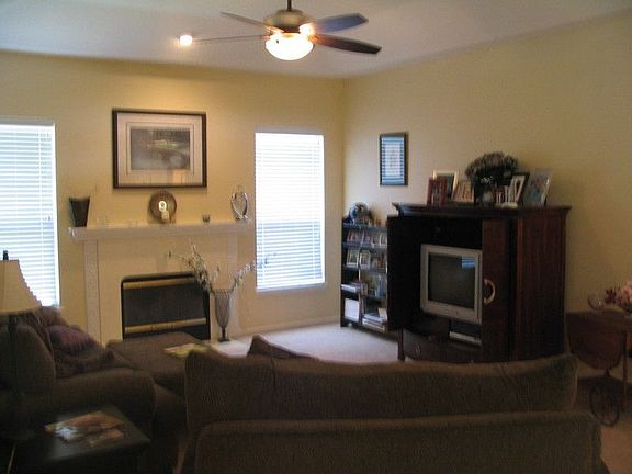 Family Room with Fireplace and ceiling Fan. New Carpet!