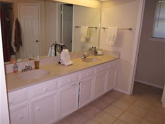 MASTER BATH HAS DOUBLE SINKS AND HIS AND HERS CLOSETS.