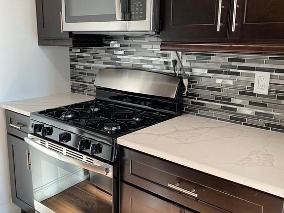 Kitchen with stainless microwave and stove oven
