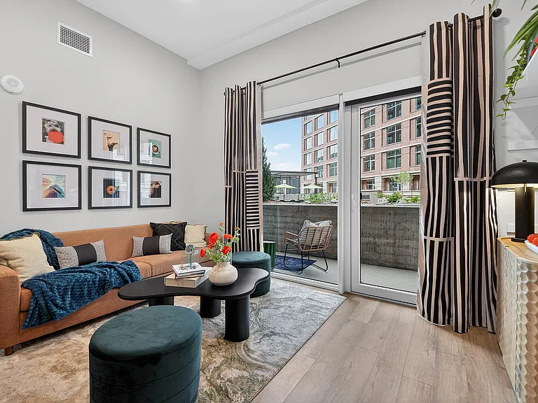 Spacious living area with city-facing window