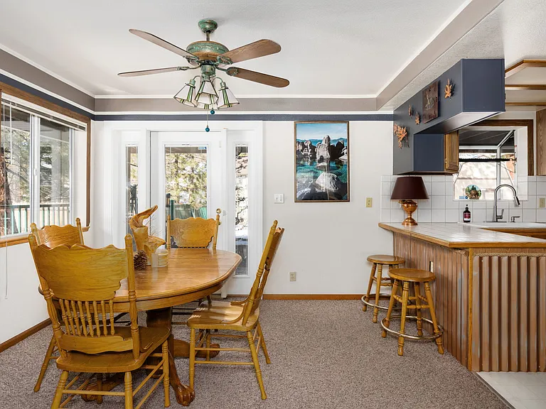 Downstairs dining table 2 of 2 with beautiful outdoor views and backyard entrance.
