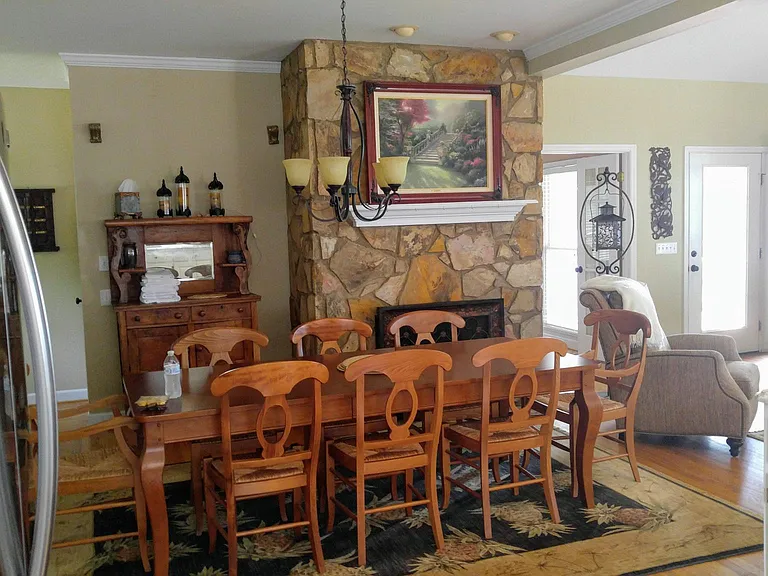 Dining....., open to kitchen, bar and great room with access to large covered deck. 8 chairs for table and 3 at counter. MBR is to the right of fplc. (french doors), deck door is to the right of mbr door.