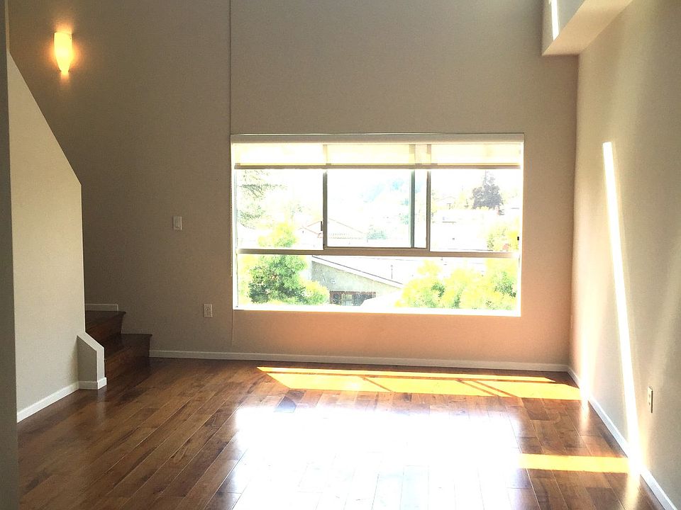Louise Apartments unfurnished living area with large window