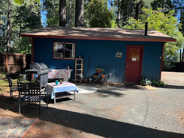 Exterior of building showing the outdoor lounge area with BBQ