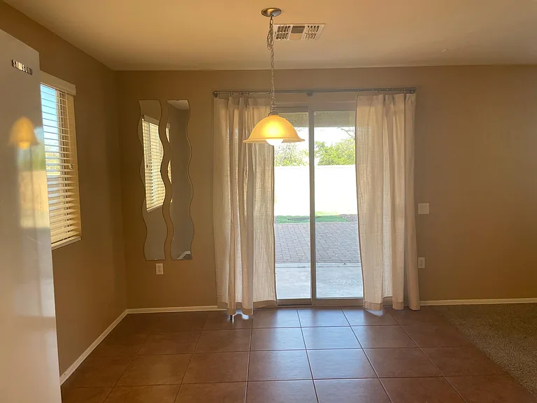 Dining room area off kitchen with backyard door