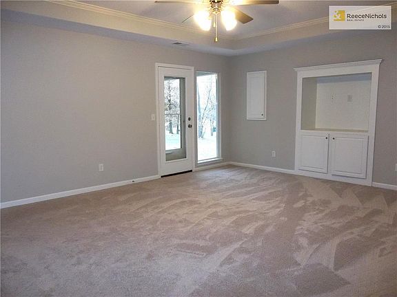 Living Room with Vaulted Ceiling, Ceiling Fan, door to Covered Patio.