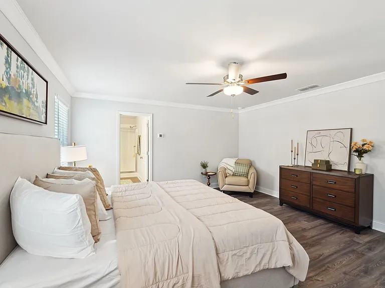 Spacious primary bedroom with a king bed and abundant natural light.