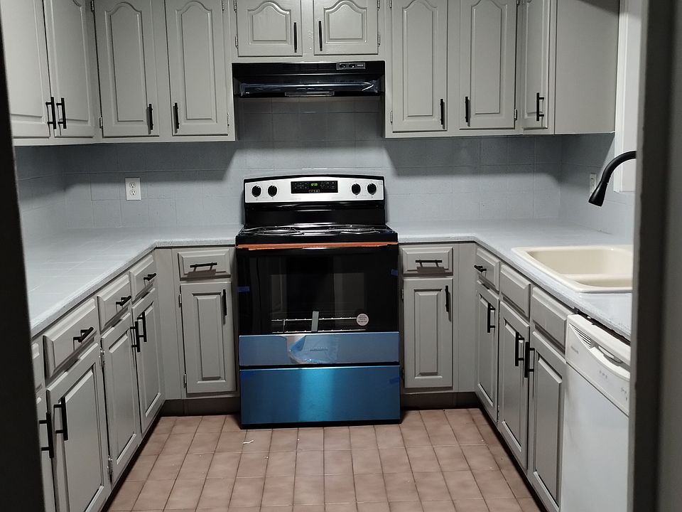Plenty of cabinets in kitchen with a pantry