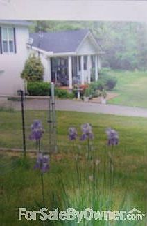 front view of home
						:
						many trees,magnolia, hydrangia,boxwood bushes,flowering, flowers and flower path