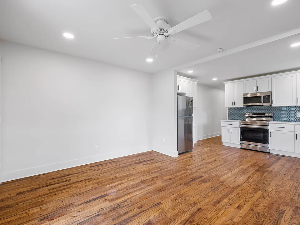 Living area w/ beautiful hardwood flooring.