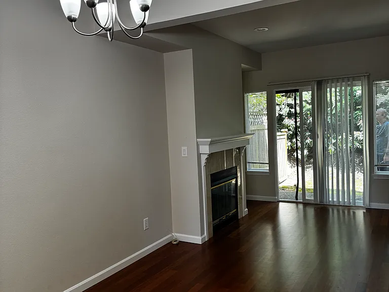 Living toom with fire place and sliding door to the small private patio