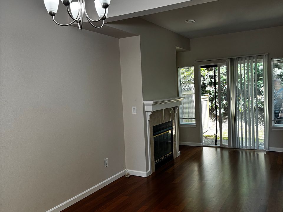 Living toom with fire place and sliding door to the small private patio