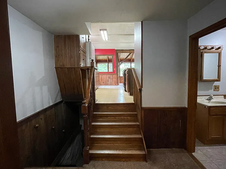 Level with entry, bedrooms and bathroom. Plus stairs heading to kitchen, dining and living area and stairs to basement.