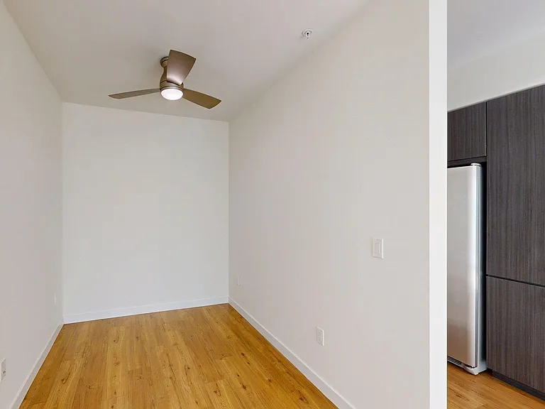 Spacious apartment Bedroom with Wood-Style Flooring.