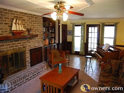 family room with fire place & woodbox, view of creek