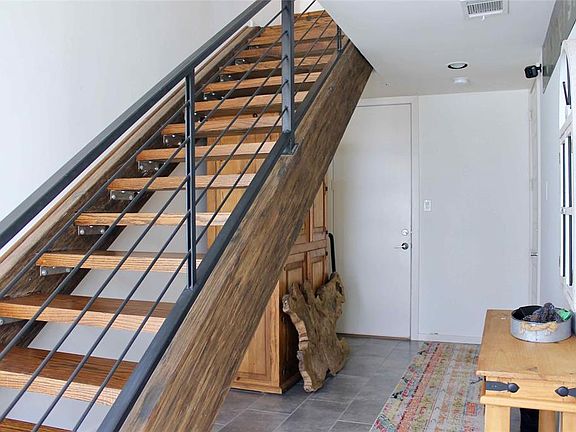 At the entrance you will find a foyer and doors with access to the garage and back of the building