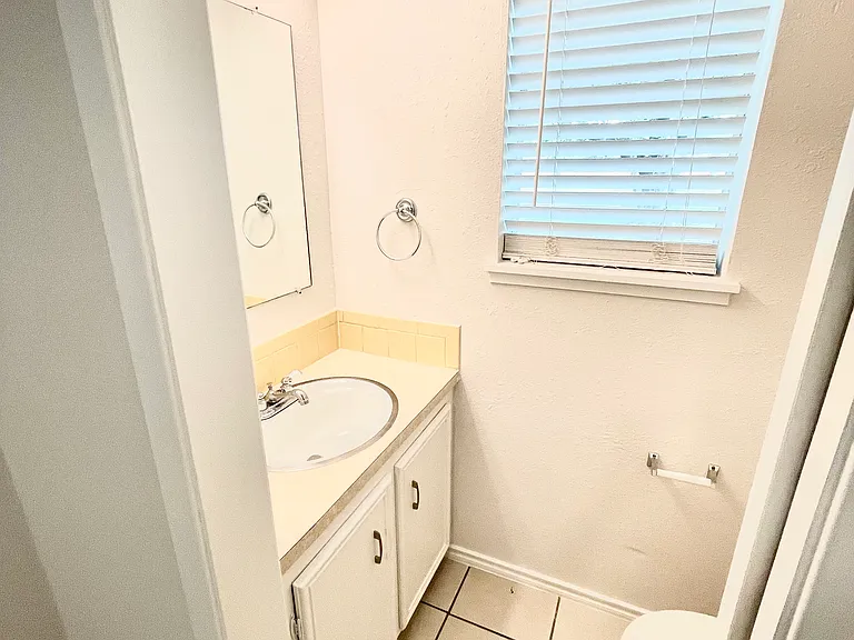 Half bath at far end of the laundry room