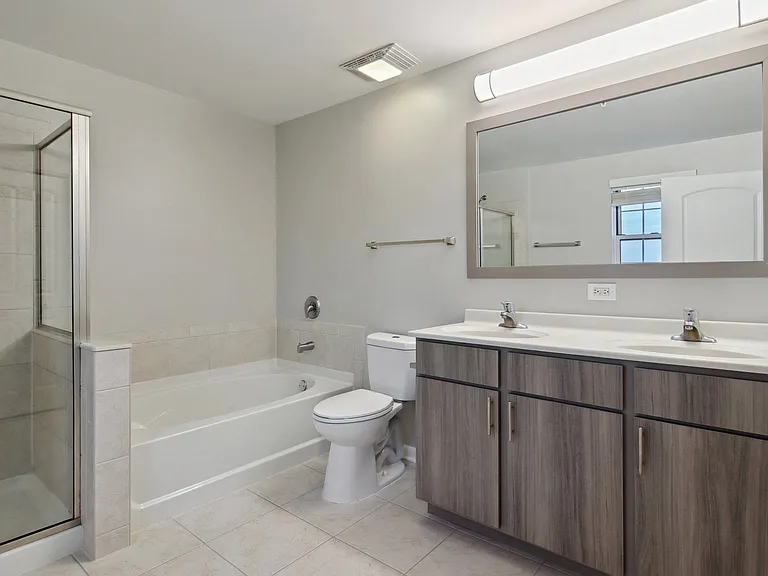 Modern bathroom with double vanity and soaking tub