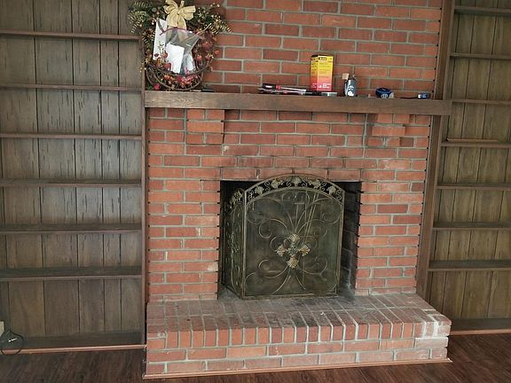 Dining room with fireplace and built in shelves
