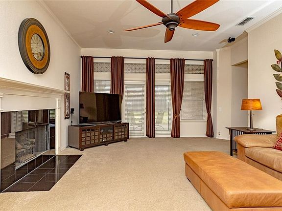 Family room hosts large fireplace that has gas logs. Transom windows. Wired for surround sound.