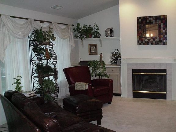 Living room with fireplace, high ceiling