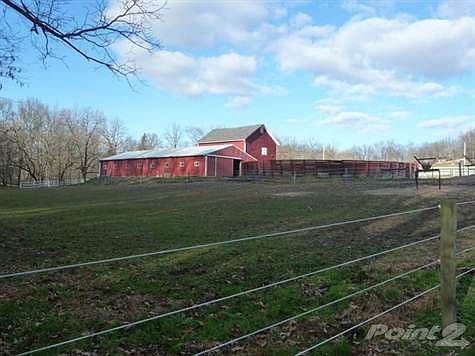 view of stable, barn & pen from back pasture