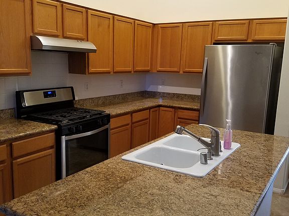 Great working kitchen with stainless steel appliances and gr