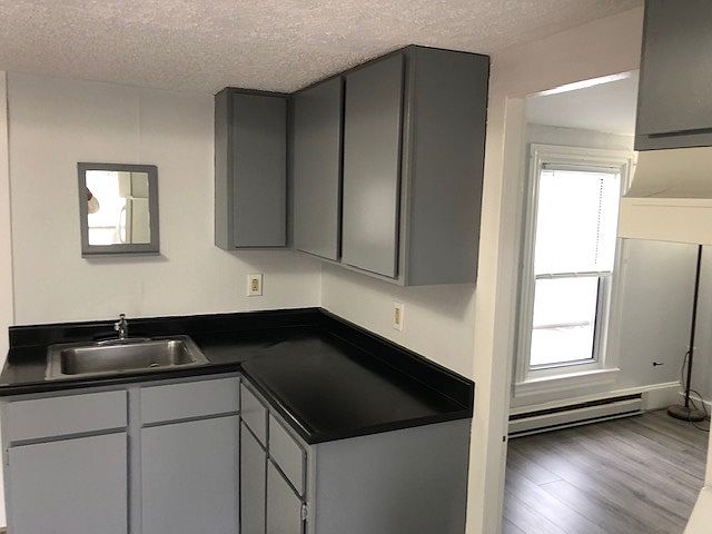 kitchen cabinets with partial bedroom views