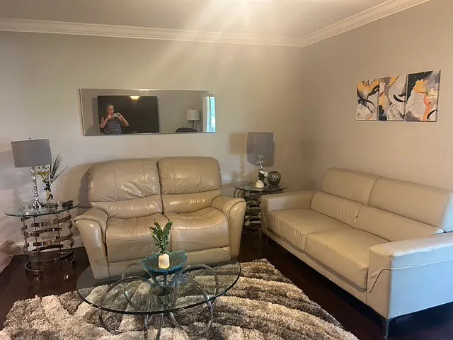 living room with matching leather sofa and loveseat, end tables, coffee table