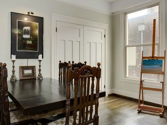 High ceilings, original wood floors, trim work & crown moulding add to the charm & character. Murphy bed behind double doors.