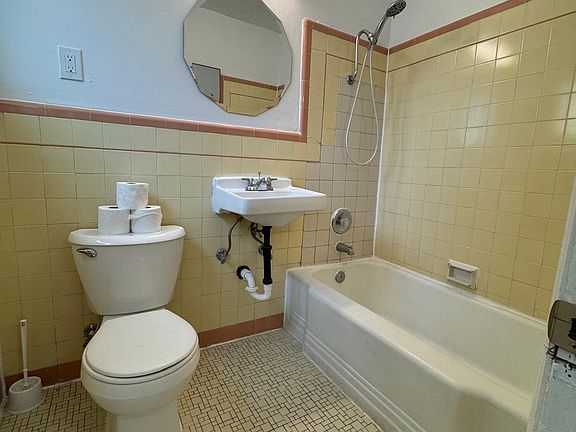 Full Bathroom featuring sink, toilet, and bathtub and shower.