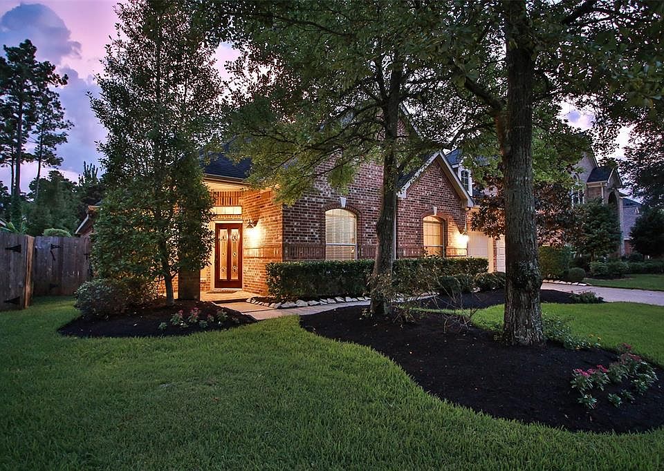 The beautiful night sky highlights all the trees surrounding this Plantation Homes 2-story in Coles Crossing.