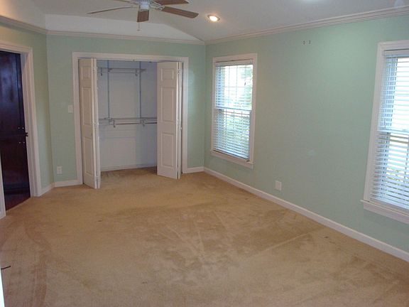 master room showing high ceilings, closet and door to master bath