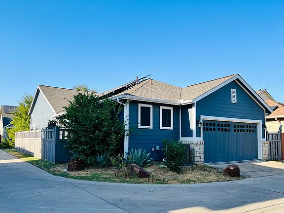 Side view of house and 2 car garage in back