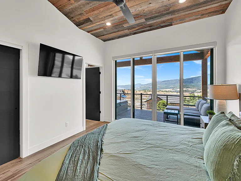 Master bedroom with closet, smart tv, and private bathroom, with French doors to the deck
