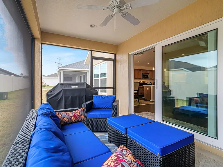 Enclosed Birdcage/Lanai with a Ceiling Fan and Access to the Concrete Patio for Grilling.