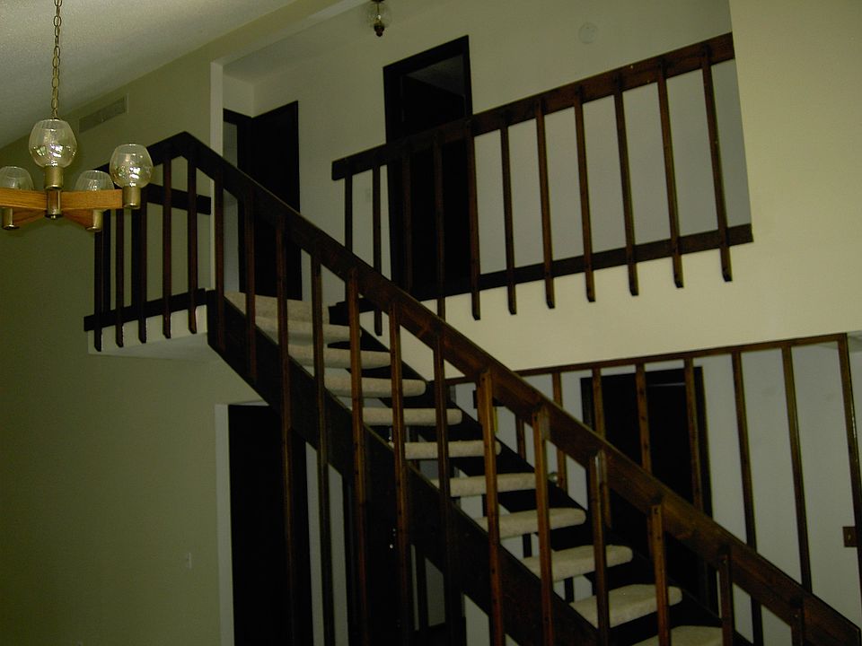 Stairs and Balcony leading to 2 bedrooms and a bathroom